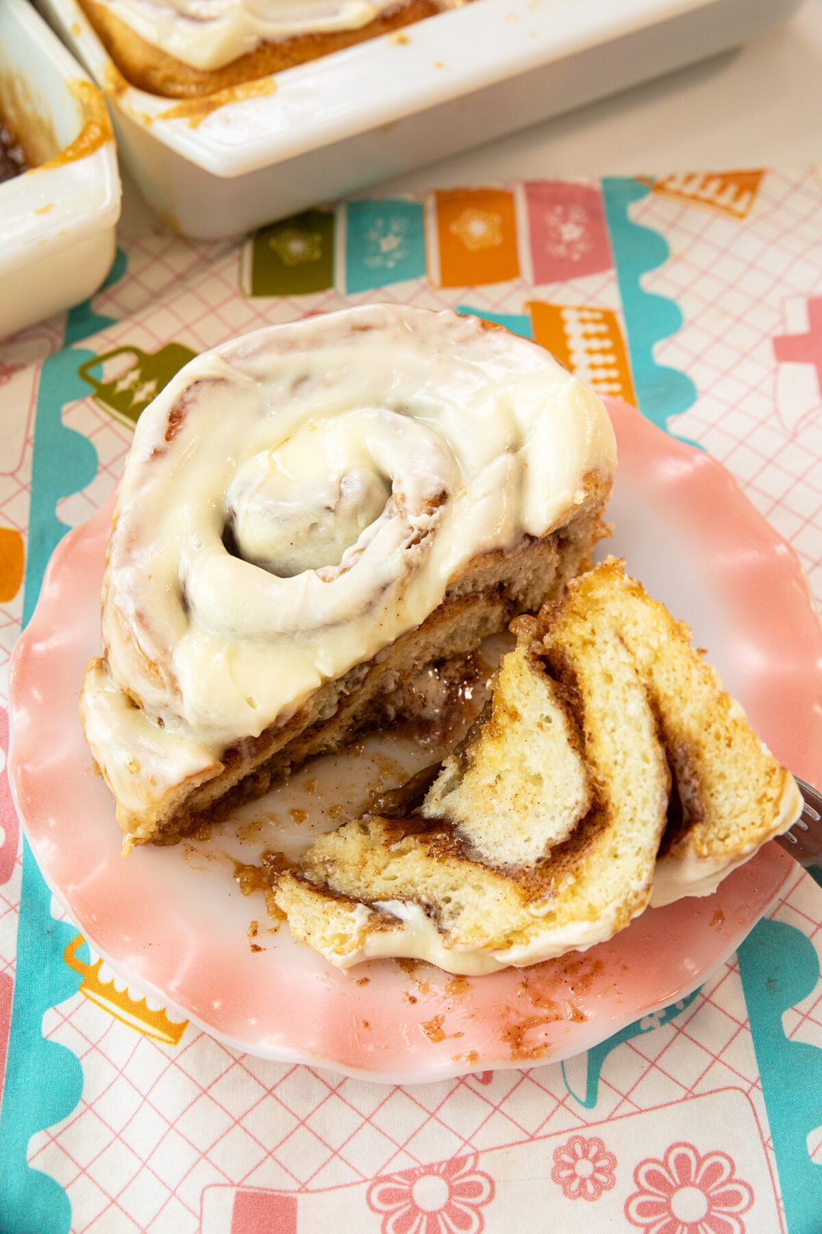 slice cinnamon roll on a pink plate
