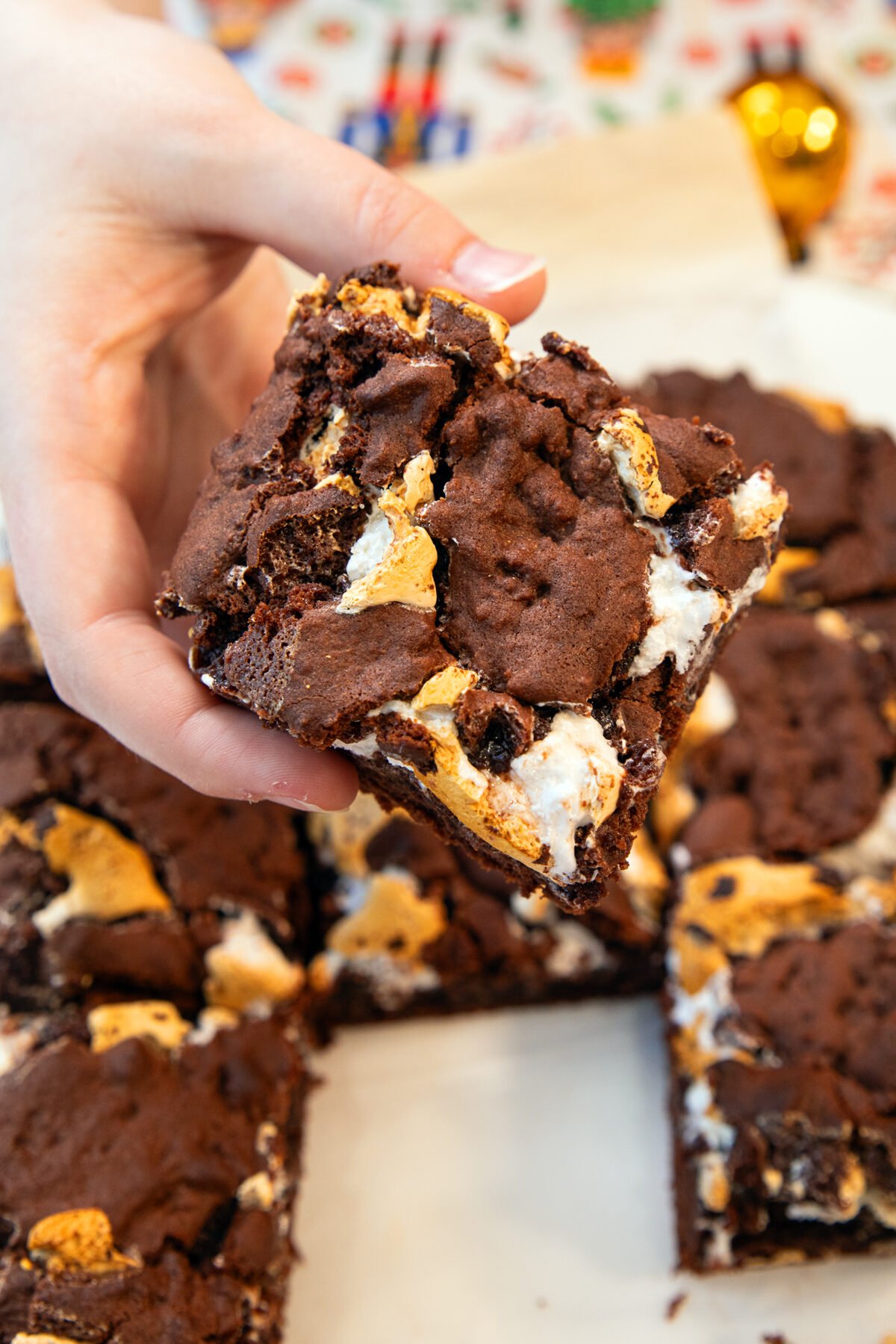a hand holding marshmallow brownies