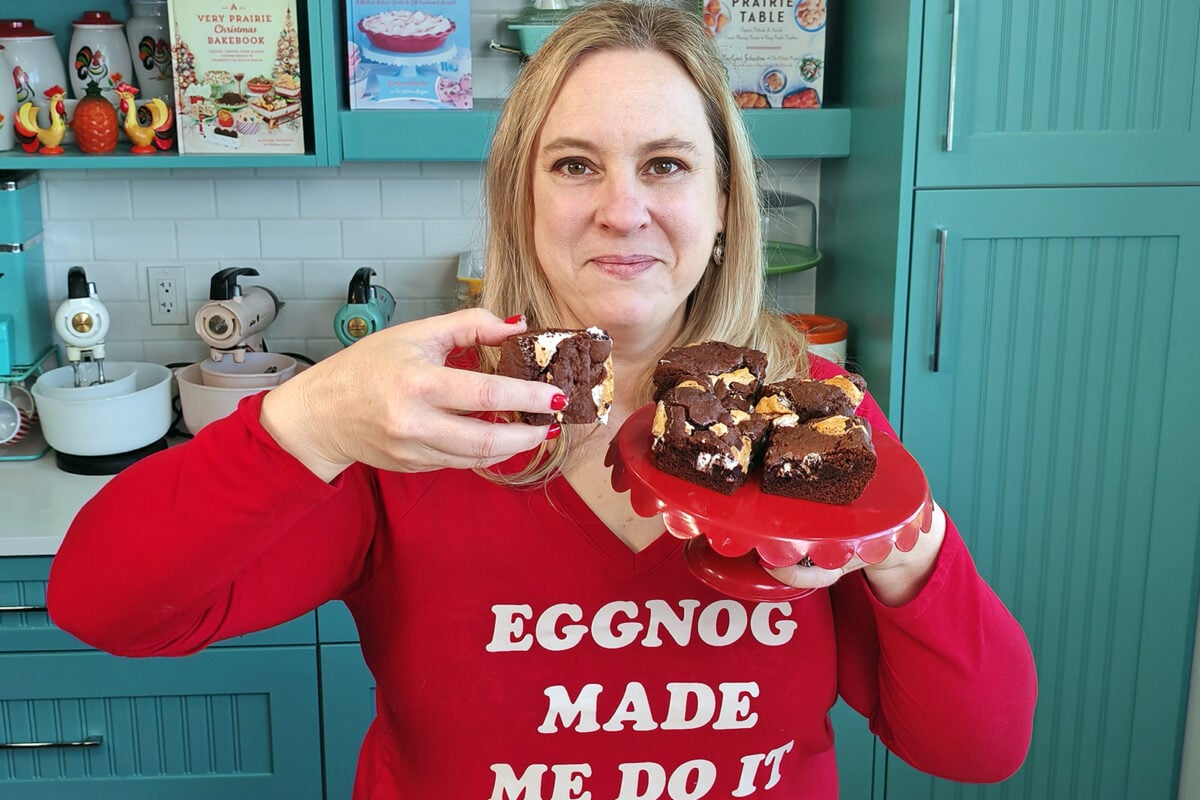 Karlynn holding a plate of her marshmallow brownies in her kitchen
