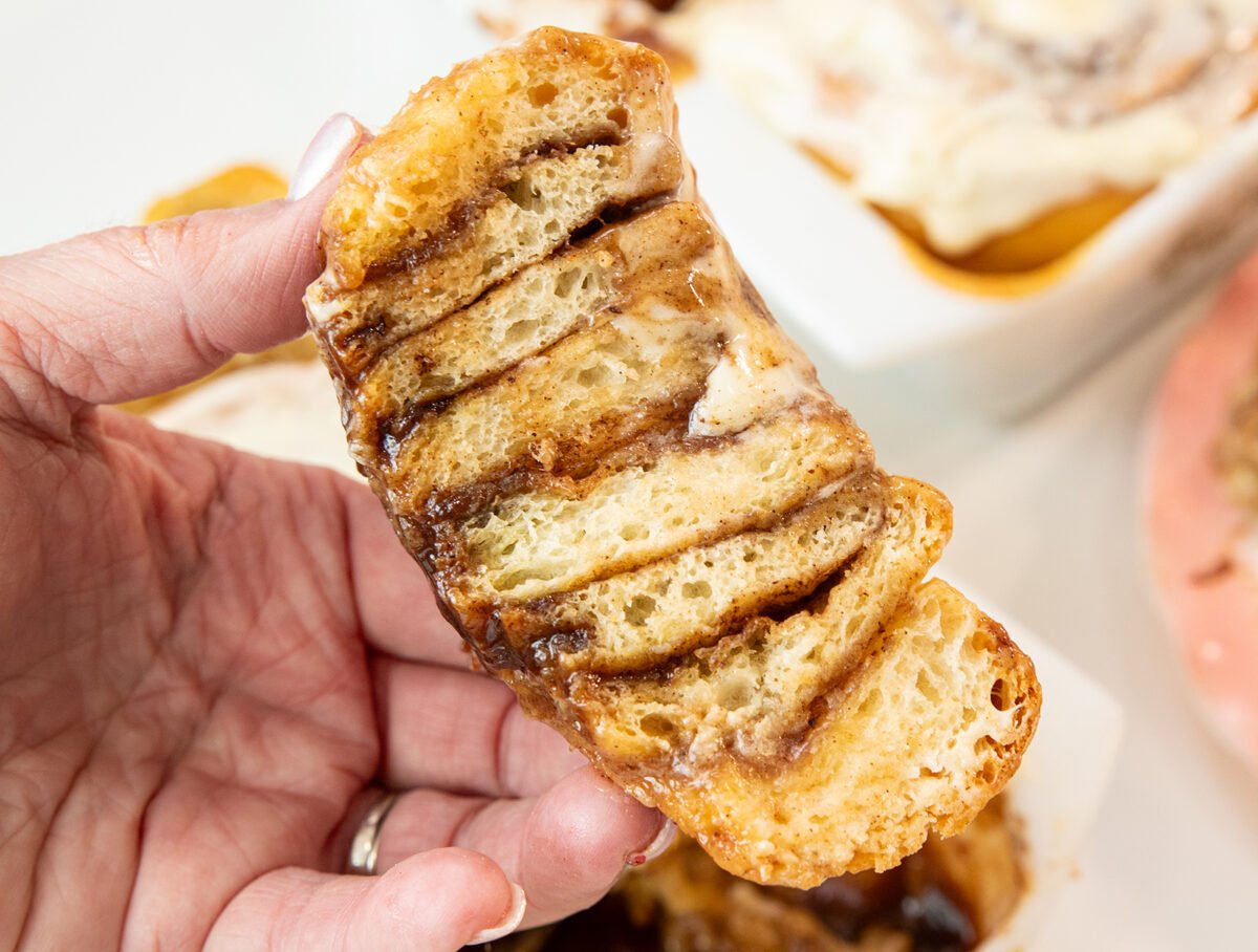 Cinnamon roll sliced in half to show that they are baked to the middle