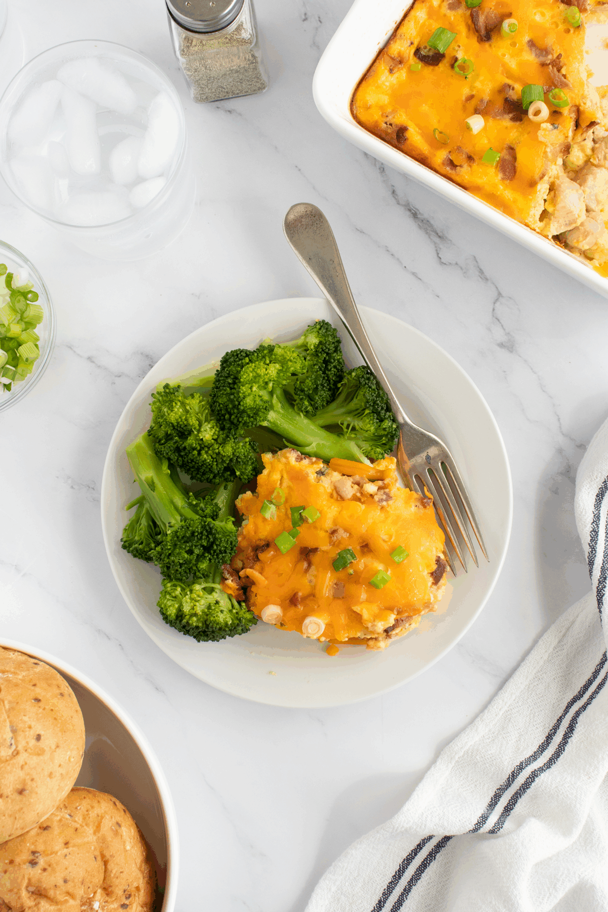 A plate of food with a fork and broccoli.