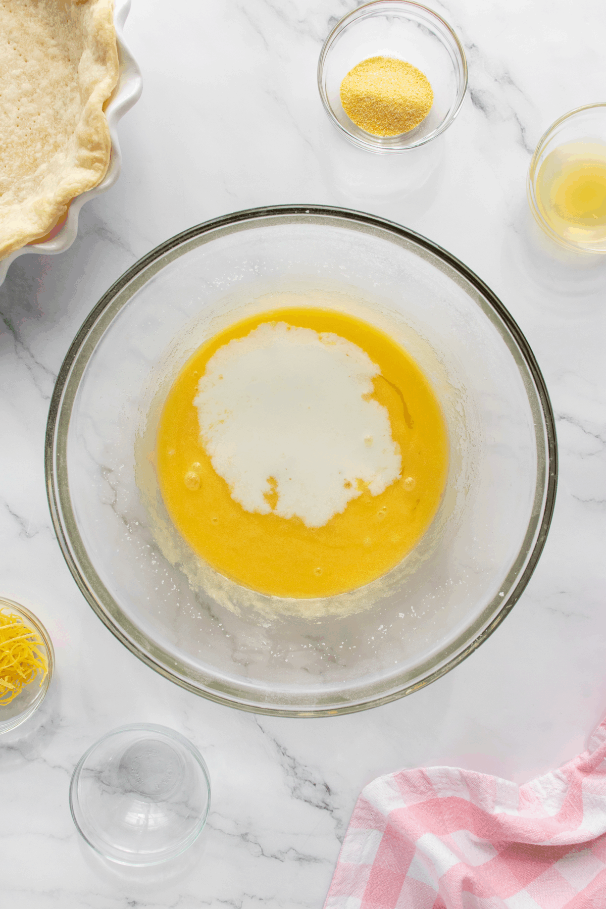 A bowl of egg yolk and some ingredients.