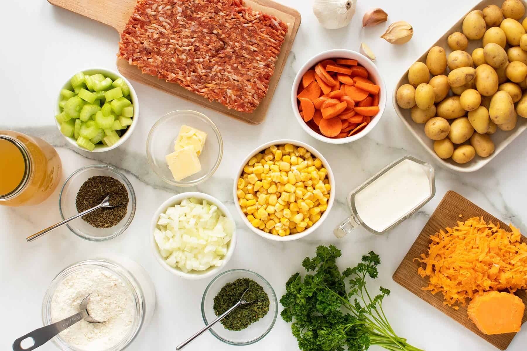 creamy sausage potato soup ingredients in small white bowls